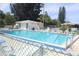 Community pool area with crystal-clear water, surrounded by ample seating and well-maintained landscaping at 12400 Park Blvd # 408, Seminole, FL 33772