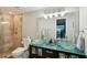 Modern bathroom with glass bowl sinks, updated lighting, and a glass-enclosed shower with marble tiling at 14910 Northwood Village Ln, Tampa, FL 33613
