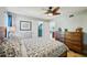 Cozy bedroom featuring a ceiling fan, plush bed, and a window at 14910 Northwood Village Ln, Tampa, FL 33613