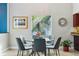 Dining room with a round table and seating for six, complimented with a decorative plant and outside view at 14910 Northwood Village Ln, Tampa, FL 33613