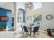 The dining room has a round glass table with seating for six, stylish lighting, and views to the outside at 14910 Northwood Village Ln, Tampa, FL 33613