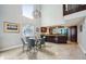 Open concept view of the dining room showcasing the kitchen, breakfast bar and a round table with seating for six at 14910 Northwood Village Ln, Tampa, FL 33613