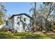 Exterior of light blue two-story home featuring numerous windows and a large screened-in porch at 14910 Northwood Village Ln, Tampa, FL 33613