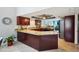 Open kitchen with granite countertops, an island, and stainless steel refrigerator at 14910 Northwood Village Ln, Tampa, FL 33613