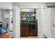 Organized laundry room closet with new, stainless steel washer and dryer units and white bi-fold doors at 14910 Northwood Village Ln, Tampa, FL 33613