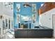 Bright living room featuring soaring ceilings, a loft, entertainment center and a comfortable, modern gray sofa at 14910 Northwood Village Ln, Tampa, FL 33613