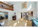 Open living space with travertine floors, high ceilings, and a view to the breakfast bar and kitchen at 14910 Northwood Village Ln, Tampa, FL 33613
