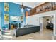 Bright living room featuring soaring ceilings, a loft, entertainment center and a comfortable, modern gray sofa at 14910 Northwood Village Ln, Tampa, FL 33613
