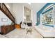 Bright, spacious living room featuring a fireplace and staircase, with modern decor at 14910 Northwood Village Ln, Tampa, FL 33613