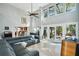 Spacious living room featuring soaring ceilings, fireplace and sliding glass doors leading to the backyard at 14910 Northwood Village Ln, Tampa, FL 33613