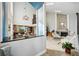 Bright, spacious living room featuring a vaulted ceiling, fireplace, and an adjacent kitchen at 14910 Northwood Village Ln, Tampa, FL 33613