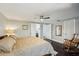 Primary bedroom showcasing hardwood floors, a king size bed and a wooden rocking chair at 14910 Northwood Village Ln, Tampa, FL 33613