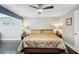 Primary bedroom featuring hardwood floors, neutral walls, and a king sized bed at 14910 Northwood Village Ln, Tampa, FL 33613