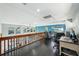 Upper level office space featuring hardwood floors and a railing overlooking lower level at 14910 Northwood Village Ln, Tampa, FL 33613