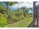 Manicured backyard featuring lush landscaping and a view of the screened lanai at 1503 Yale Castle Ct, Ruskin, FL 33570