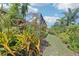 Well-maintained backyard with beautiful landscaping and a glimpse of the screened lanai at 1503 Yale Castle Ct, Ruskin, FL 33570