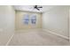 Neutral bedroom with carpet flooring, ceiling fan, and natural light from two windows, offering a cozy atmosphere at 1503 Yale Castle Ct, Ruskin, FL 33570