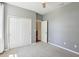 Bedroom featuring carpeted floors, a ceiling fan, and a closet at 1503 Yale Castle Ct, Ruskin, FL 33570