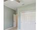 Bedroom with closet and open door. Ceiling fan and light colored walls provide a bright interior at 1503 Yale Castle Ct, Ruskin, FL 33570