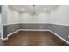 Elegant dining room with hardwood floors, wainscoting, and chandelier, creating a refined ambiance for gatherings at 1503 Yale Castle Ct, Ruskin, FL 33570