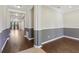Inviting entryway showcasing hardwood floors, gray accent wall, and decorative trim, seamlessly connecting living spaces at 1503 Yale Castle Ct, Ruskin, FL 33570