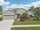 Charming single-story home featuring a well-manicured lawn, beautiful landscaping, and an attached two-car garage at 1503 Yale Castle Ct, Ruskin, FL 33570