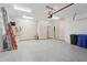 Spacious garage featuring sealed concrete flooring and ample overhead lighting at 1503 Yale Castle Ct, Ruskin, FL 33570