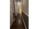 Hallway with dark floors, neutral walls, and white trim for a clean, modern look at 1503 Yale Castle Ct, Ruskin, FL 33570