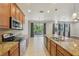 Well-equipped kitchen featuring granite countertops, tile backsplash, stainless steel appliances, and lots of storage at 1503 Yale Castle Ct, Ruskin, FL 33570