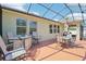 Enclosed patio with comfortable seating and a dining table, perfect for relaxing outdoors at 1503 Yale Castle Ct, Ruskin, FL 33570