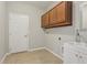 Functional laundry room with ample cabinet space and a convenient utility sink at 1503 Yale Castle Ct, Ruskin, FL 33570