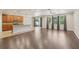 Open-concept living room features dark wood floors, abundant natural light from large windows, and an eat-in kitchen at 1503 Yale Castle Ct, Ruskin, FL 33570