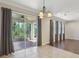 Spacious living room with a large glass slider for outdoor access and a combination of tile and hardwood flooring at 1503 Yale Castle Ct, Ruskin, FL 33570