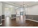 Open-concept living space with hardwood floors, wainscoting, and views of the kitchen, perfect for entertaining at 1503 Yale Castle Ct, Ruskin, FL 33570