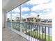 Screened-in balcony overlooking the waterfront with beautiful views of the canal, docks, and nearby buildings at 1623 Sea Haven Dr # 307, Punta Gorda, FL 33950