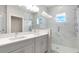 Elegant bathroom with a double vanity, marble walls, and a glass-enclosed shower at 1623 Sea Haven Dr # 307, Punta Gorda, FL 33950