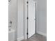 Bright bathroom with white tile and an open doorway revealing wood-look floors at 1623 Sea Haven Dr # 307, Punta Gorda, FL 33950