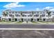 Charming townhomes with gray exterior, well-manicured landscaping, and individual garages, creating a welcoming curb appeal at 1623 Sea Haven Dr # 307, Punta Gorda, FL 33950