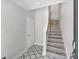Hallway with staircase, tile flooring, and white walls at 1623 Sea Haven Dr # 307, Punta Gorda, FL 33950