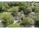 Aerial view of a home featuring a screened-in pool, mature trees, and a well-maintained yard at 17807 Crystal Cove Pl, Lutz, FL 33548