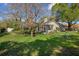 Beautiful, large backyard showcasing mature landscaping and an inviting screened-in porch, perfect for relaxation at 17807 Crystal Cove Pl, Lutz, FL 33548