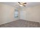 Neutral bedroom featuring ceiling fan and double door closet at 17807 Crystal Cove Pl, Lutz, FL 33548