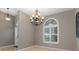 Bright dining room featuring arched windows and elegant chandelier is perfect for gatherings at 17807 Crystal Cove Pl, Lutz, FL 33548
