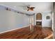 Open living room with hardwood floors, a fireplace, and bright natural light at 17807 Crystal Cove Pl, Lutz, FL 33548