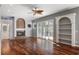 Bright living room with hardwood floors, a fireplace, and sliding glass doors to the outdoor patio at 17807 Crystal Cove Pl, Lutz, FL 33548