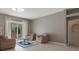 Comfortable living room with tile floors and sliding glass doors that offer plentiful natural light at 17807 Crystal Cove Pl, Lutz, FL 33548