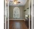 Well-lit home office featuring hardwood floors, large arched window, and a built-in aquarium at 17807 Crystal Cove Pl, Lutz, FL 33548