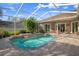 Beautiful enclosed pool area with lush landscaping, patio, and screened overhead at 17807 Crystal Cove Pl, Lutz, FL 33548