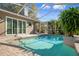 Inviting screened-in pool area with a covered outdoor kitchen, perfect for entertaining and enjoying the Florida sunshine at 17807 Crystal Cove Pl, Lutz, FL 33548