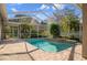 Beautifully maintained pool with screened enclosure, brick patio, and mature landscaping at 17807 Crystal Cove Pl, Lutz, FL 33548